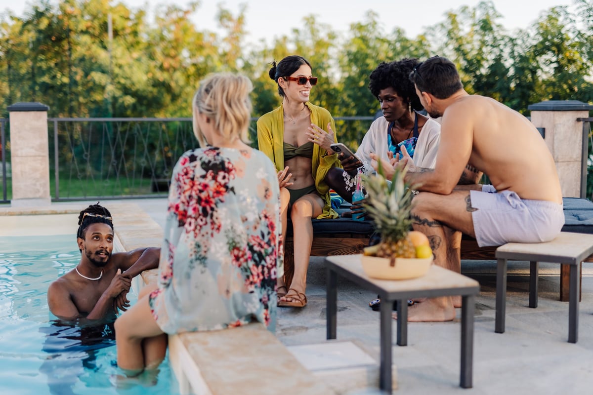 Group of diverse friends enjoying summer vacation by the pool